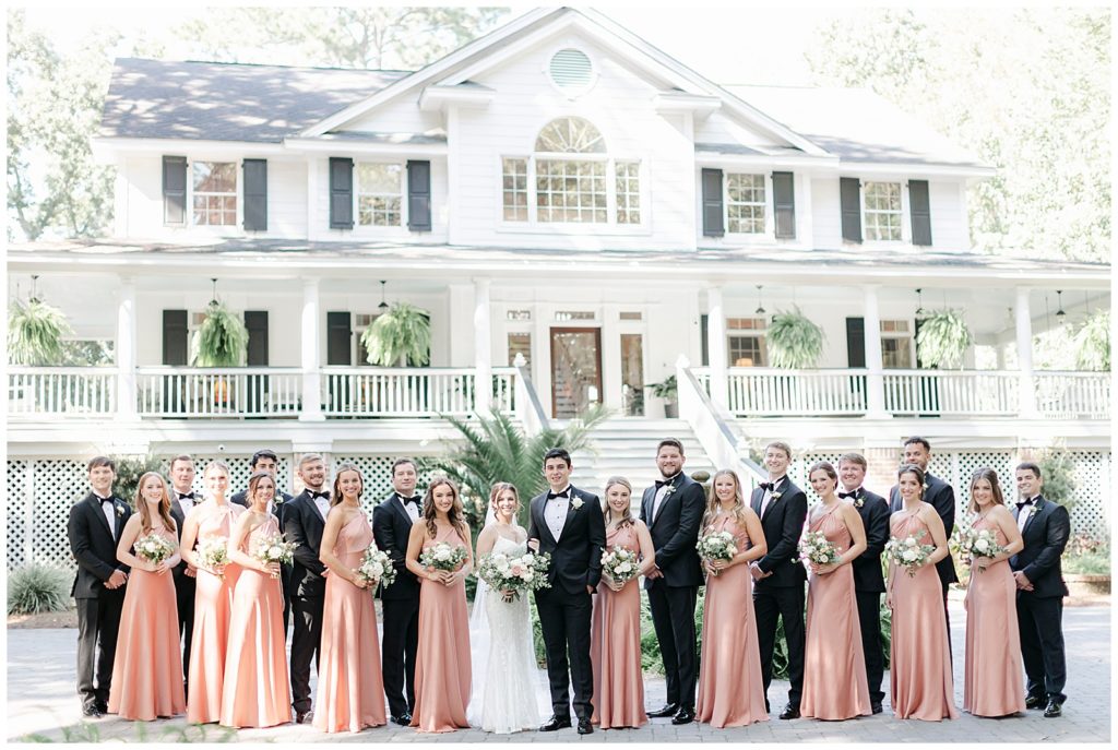 A bride party stands in front of the Mackey House in Savannah Ga. 