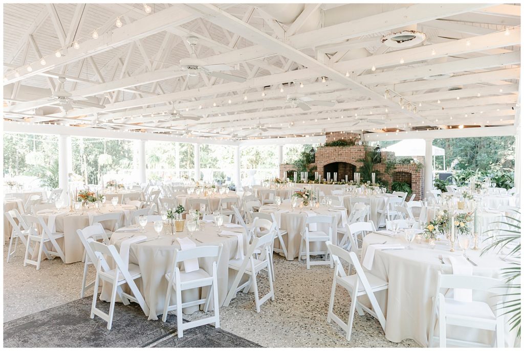 White chairs and tables under an awning. 