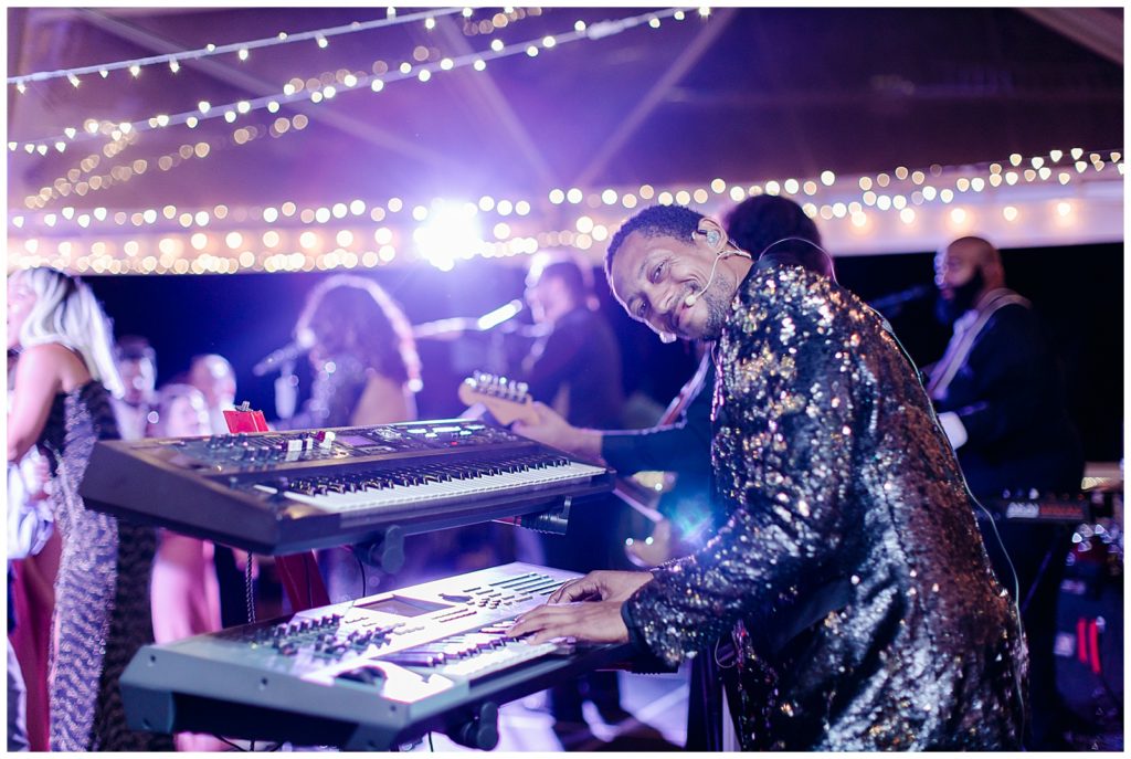 A keyboardist plays at a wedding reception. 