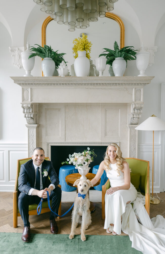 A bride and Groom sit in front of a dog at the Riggs Hotel DC.