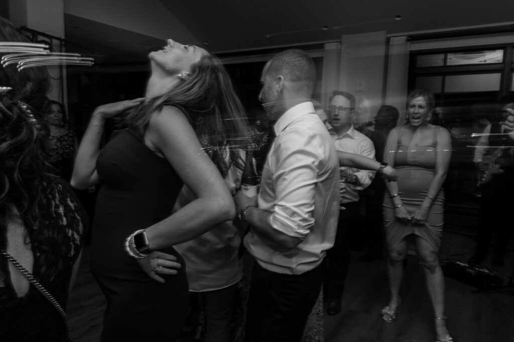 Party goers dances at a wedding receptions.