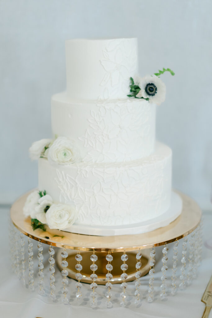 A white wedding cake with flowers. 