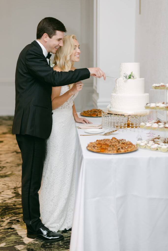 A bride and groom cutting their cake. 