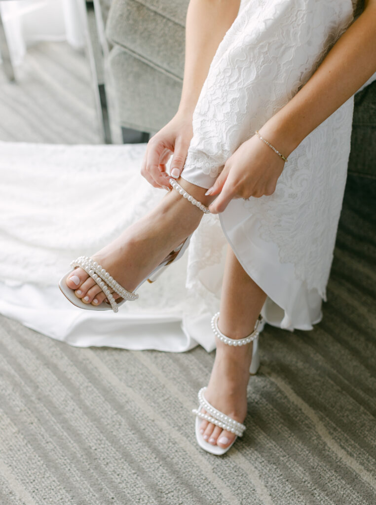 A bride placing on heels. 
