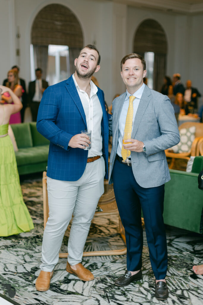 Two wedding guests holding drinks. 