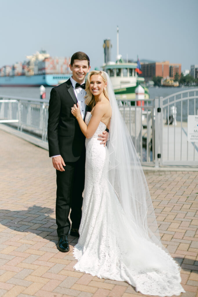 A groom and bride embrace on the docks of the Westin Savannah. 