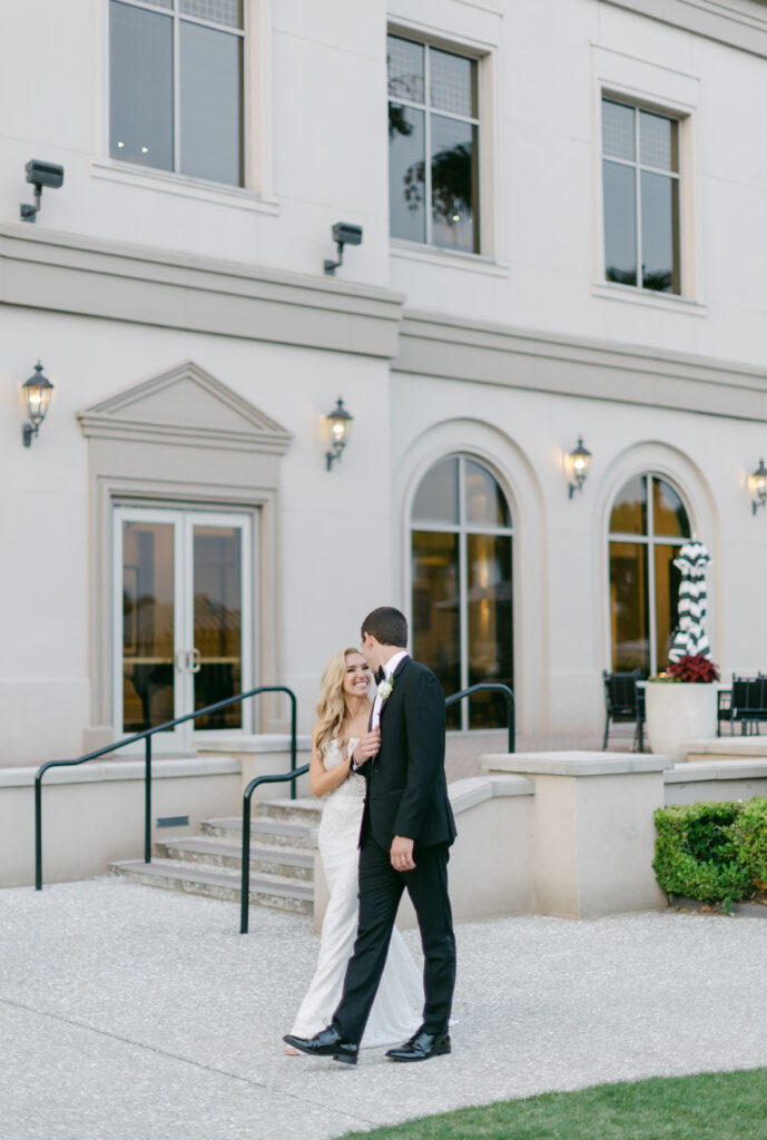 A bride and groom walk and talk at the Westin Savannah. 