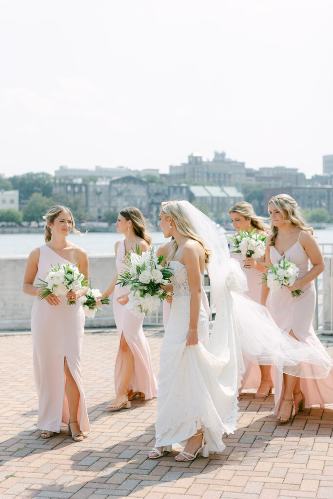 A bride laughing with her bridesmaids. 