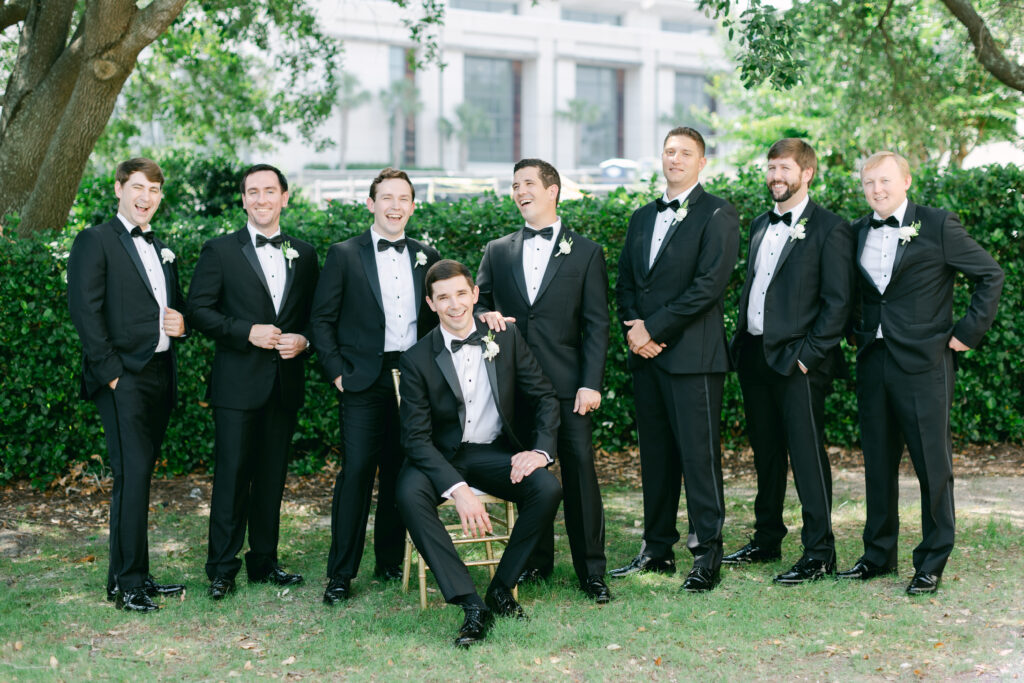 A groom laughing with his groomsmen. 