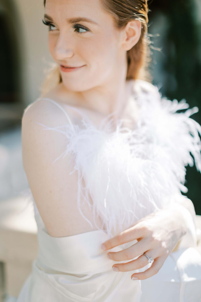 A bride in her bridal pajamas looking over her shoulder. 