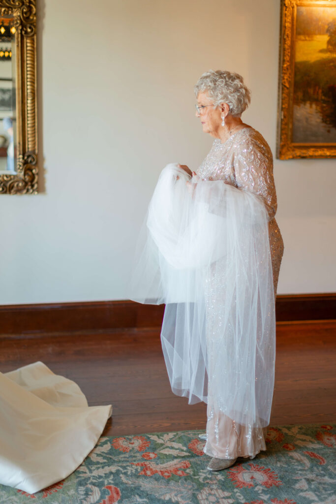 A grandmother prepares a veil. 
