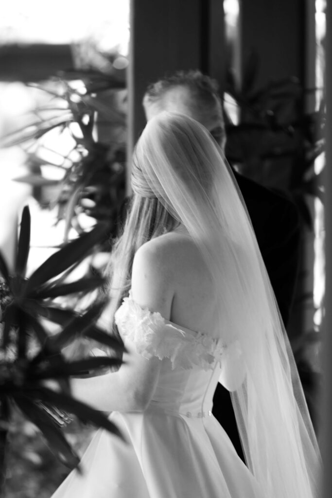 A bride prepares to walk down the aisle with her father. 