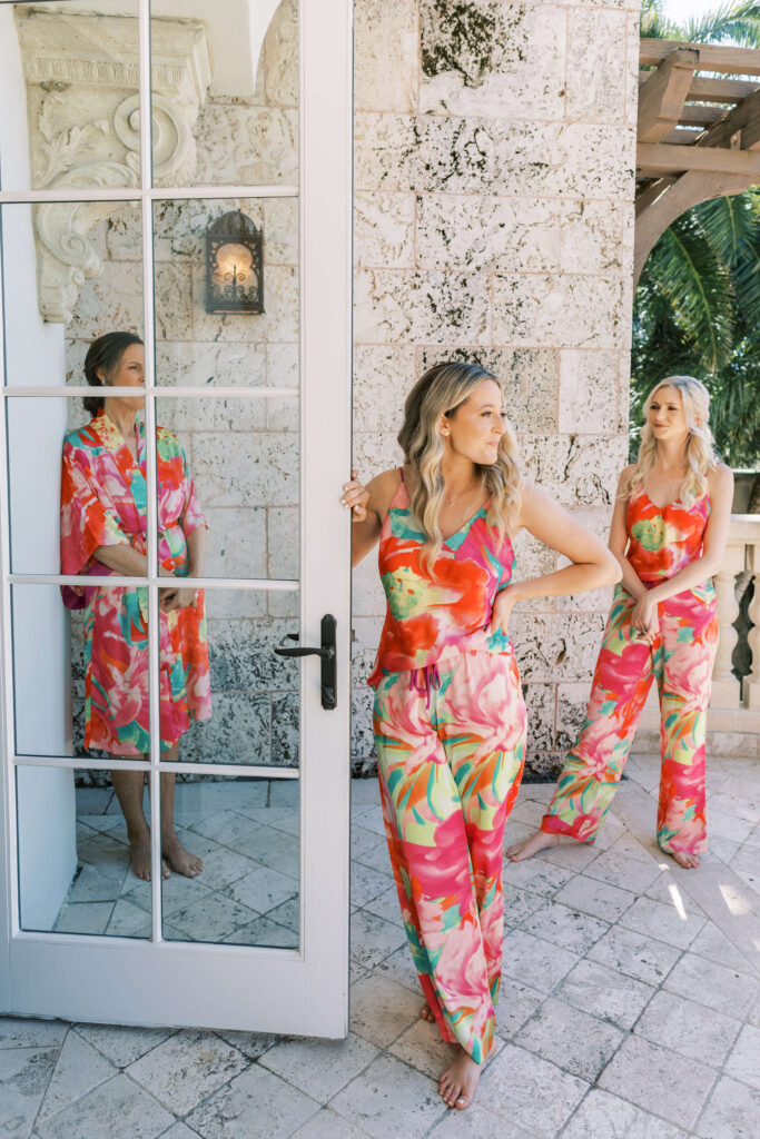 Bridesmaids in colorful pajamas standing on the Banks Parlor Balcony.