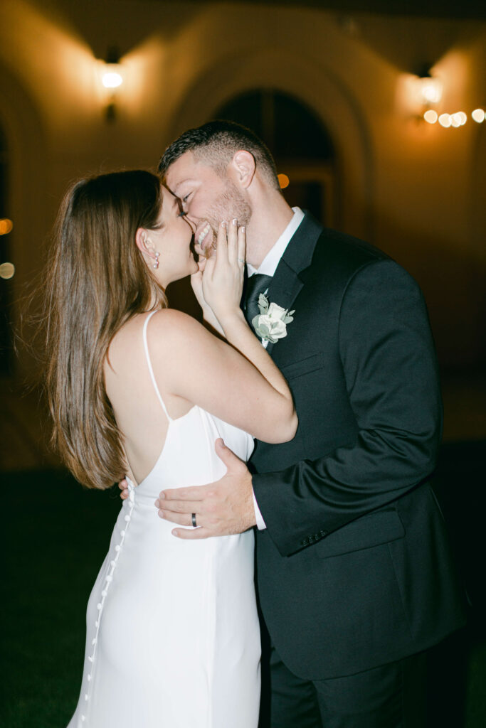 A bride and groom kiss. 