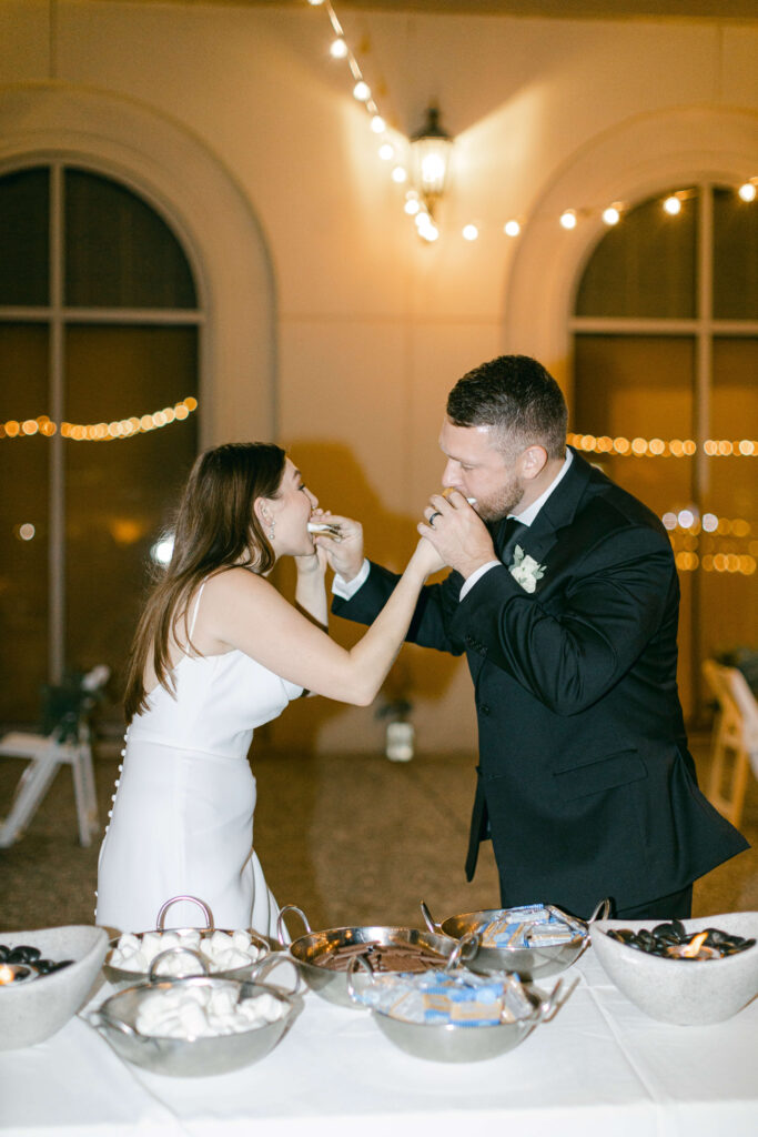 A bride and groom make s'mores
